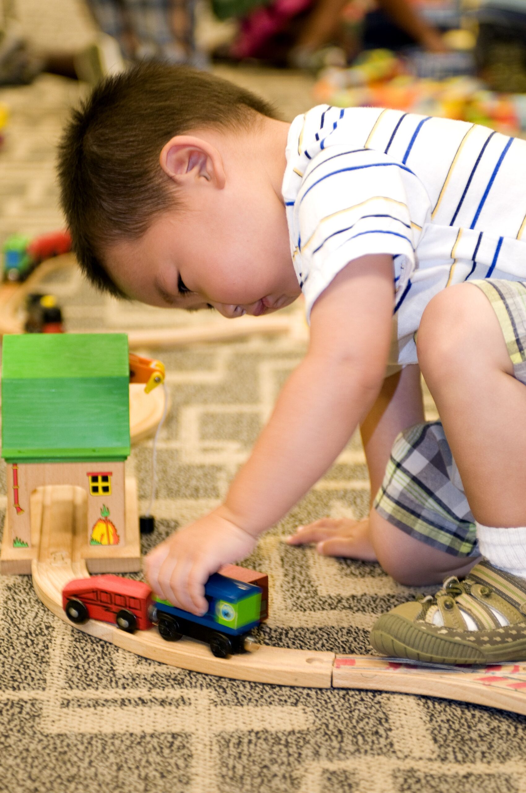Playing with a small wooden toy car set